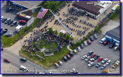 Local fire departments join together to raise a huge American Flag over the entrance to the Medina (Ohio) VFW post during a Wounded Warrior Project fundraising event.