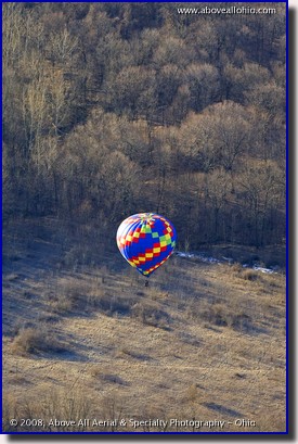 A colorful hot air ballon floats over Ohio in very early spring