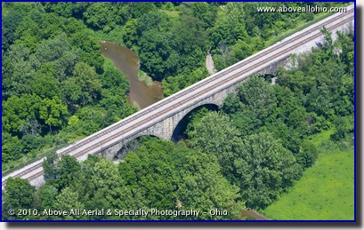 Aerial photograph of a stone arch railroad bridge